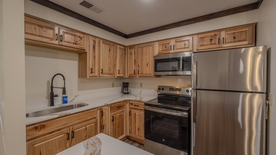 A kitchen with stainless steel appliances and granite countertop.