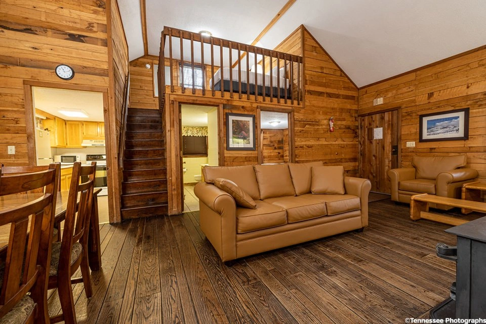 Empty loft area in a Roan Mountain cabin with wood floors and sloped ceiling.