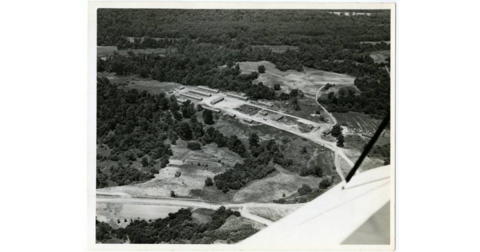 Aerial view of dirt roads and forested area.
