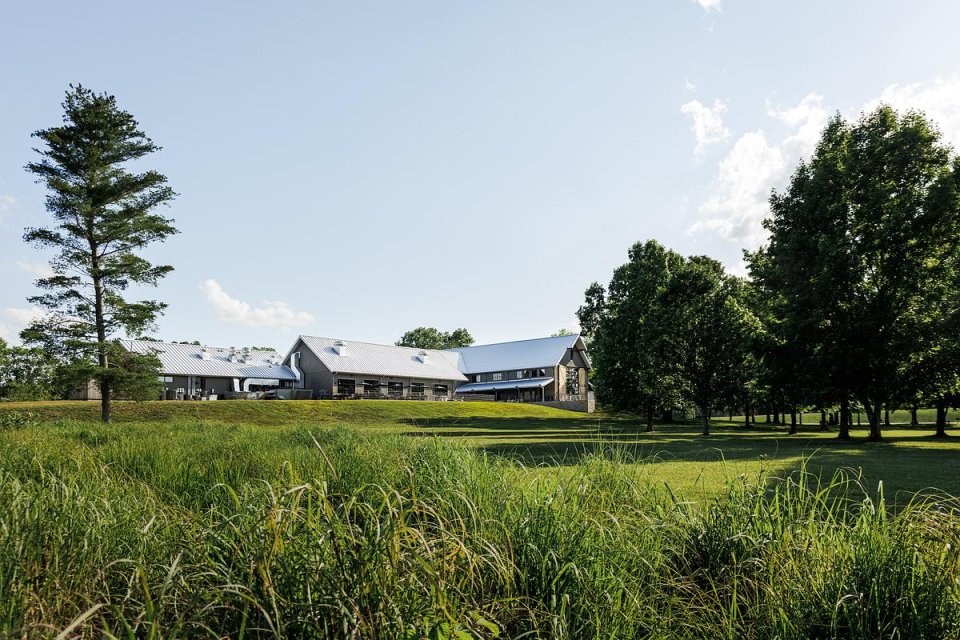 building in the distance surrounded by green trees and grass