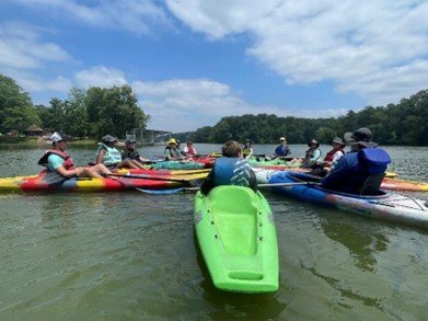 group of people kayaking on a body of water