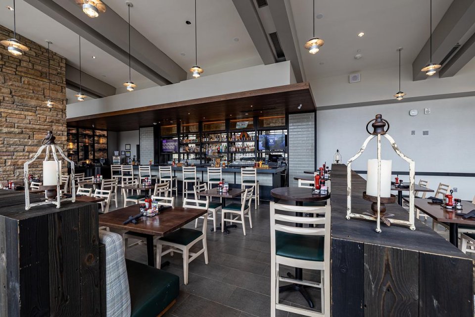 restaurant with a modern design, with a bar and filled with tables and chairs