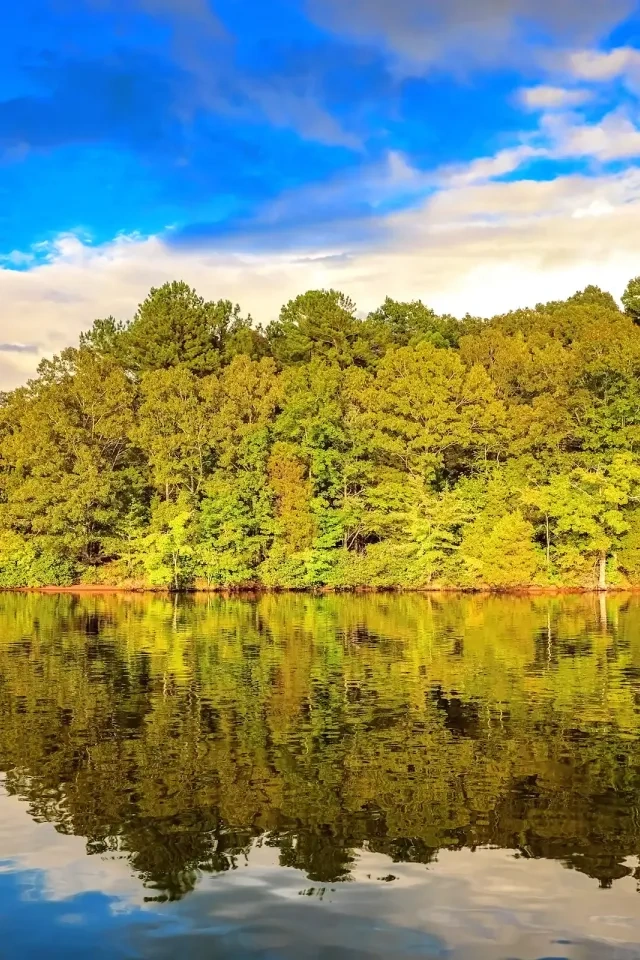 Third view of the lake showing a sandy shoreline.