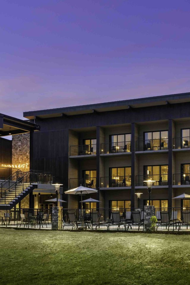 view of lodge at night with lights turned on