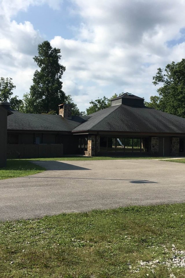 exterior of group camp 3 with a basketball hoop area in the dive way.