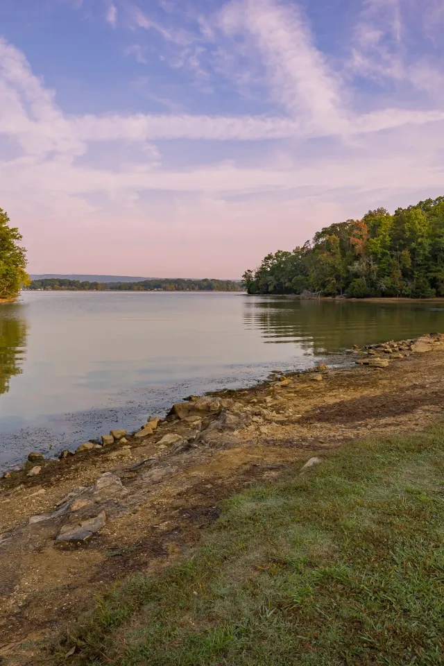 The shoreline of a lake at sunset