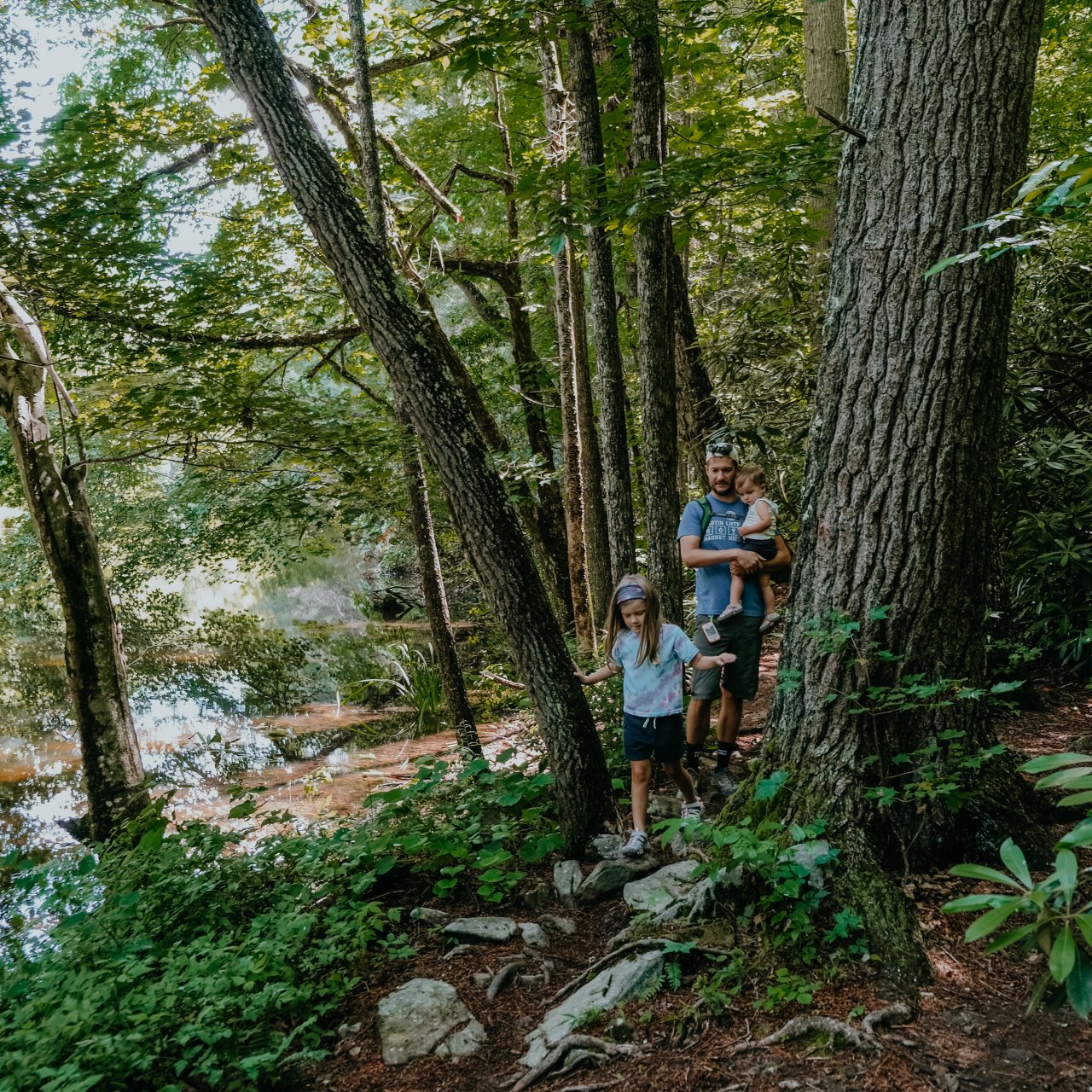 two women hiking on trail with path and trees