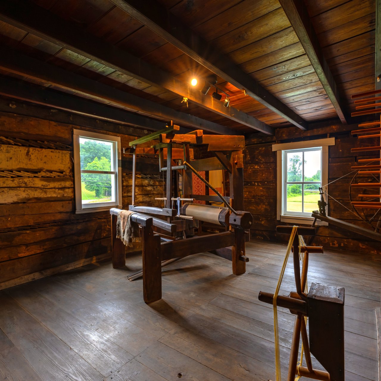 Wooden room with old fabric machine and windows