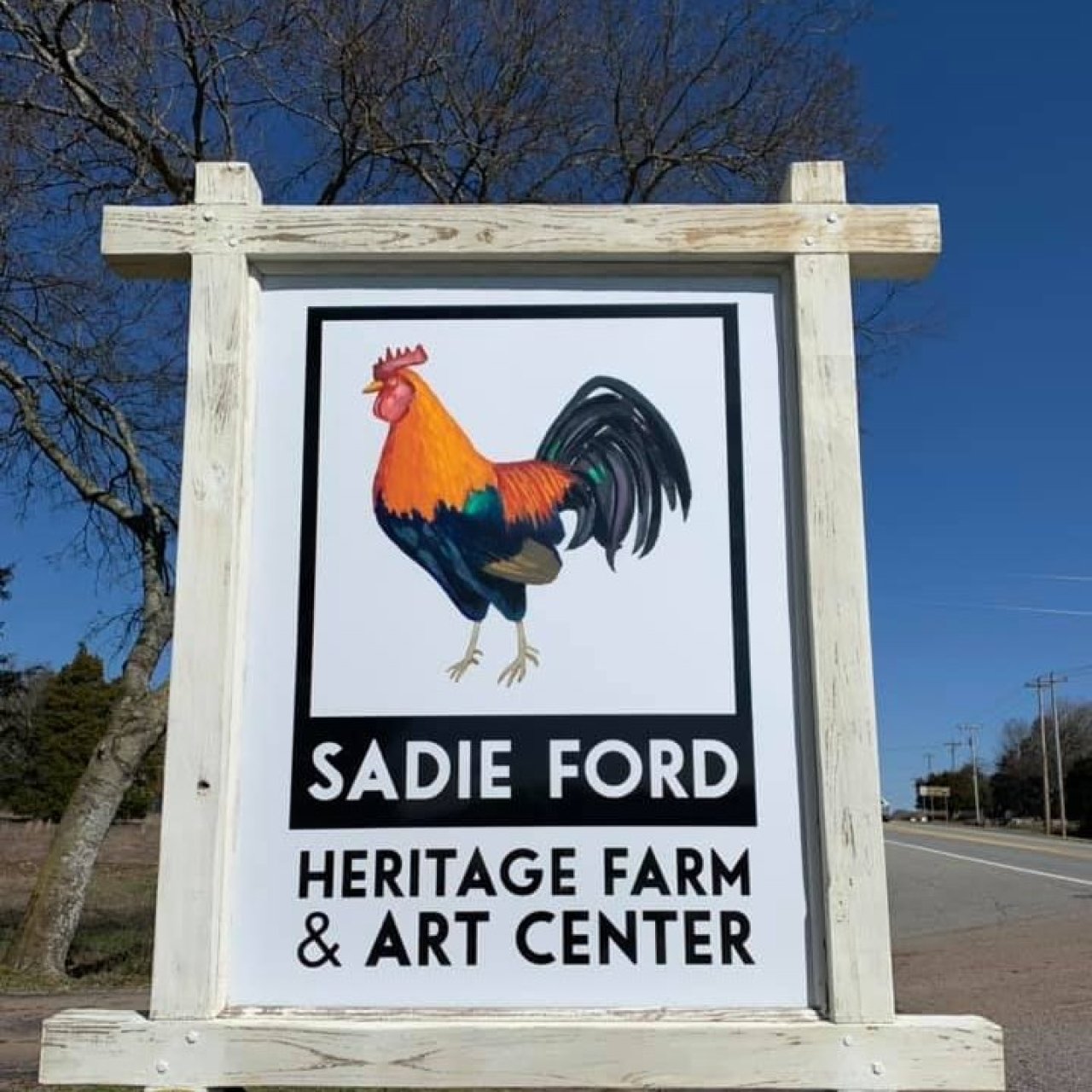 Sadie Farm heritage farm and art center sign with a picture of a rooster on it. 