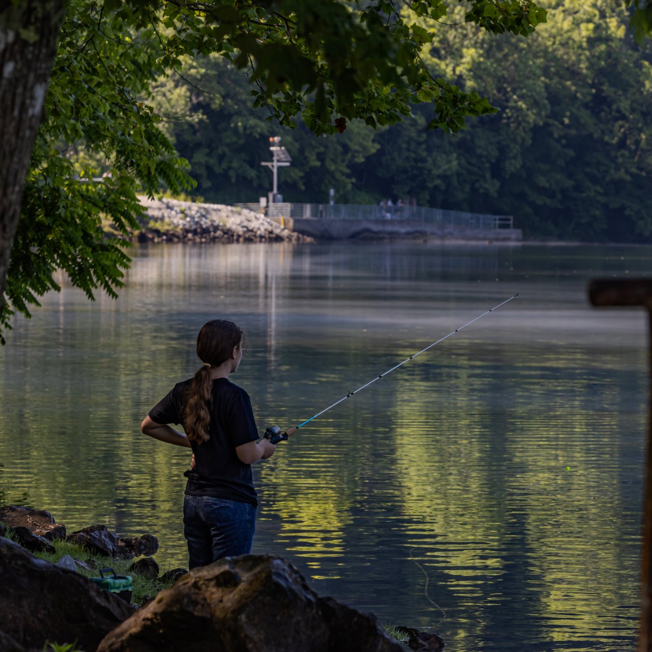 girl fishing in a river