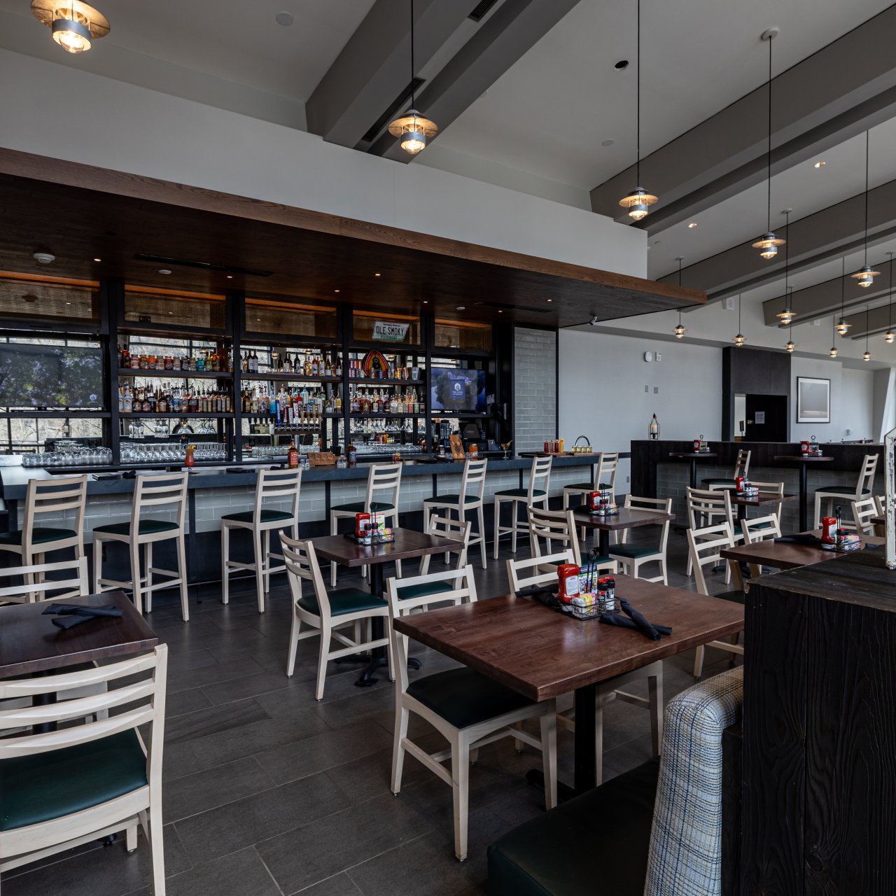 inside restaurant with tons of seating and tables with overhead and natural lighting from windows