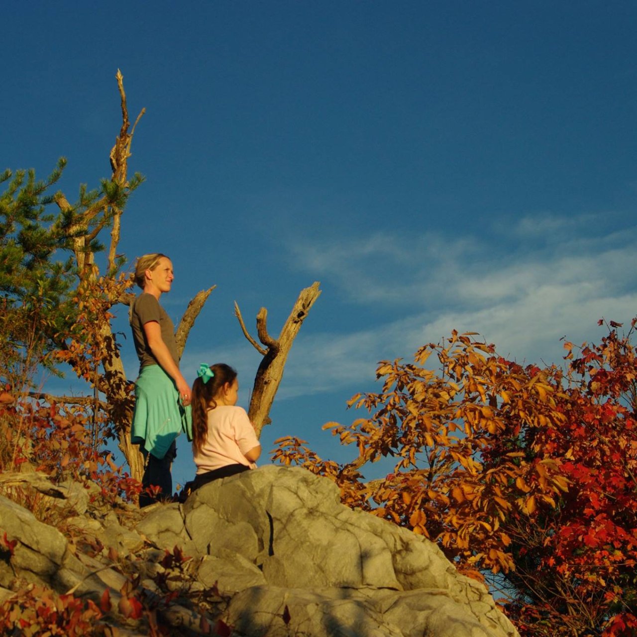 girl and lady on cliff top