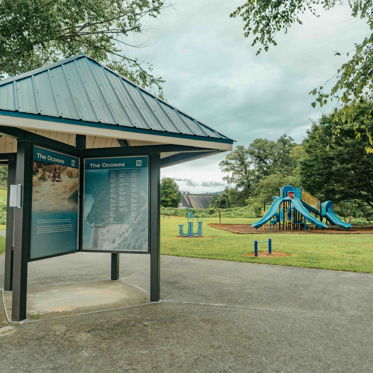 park info shelter near a playground with green equipment