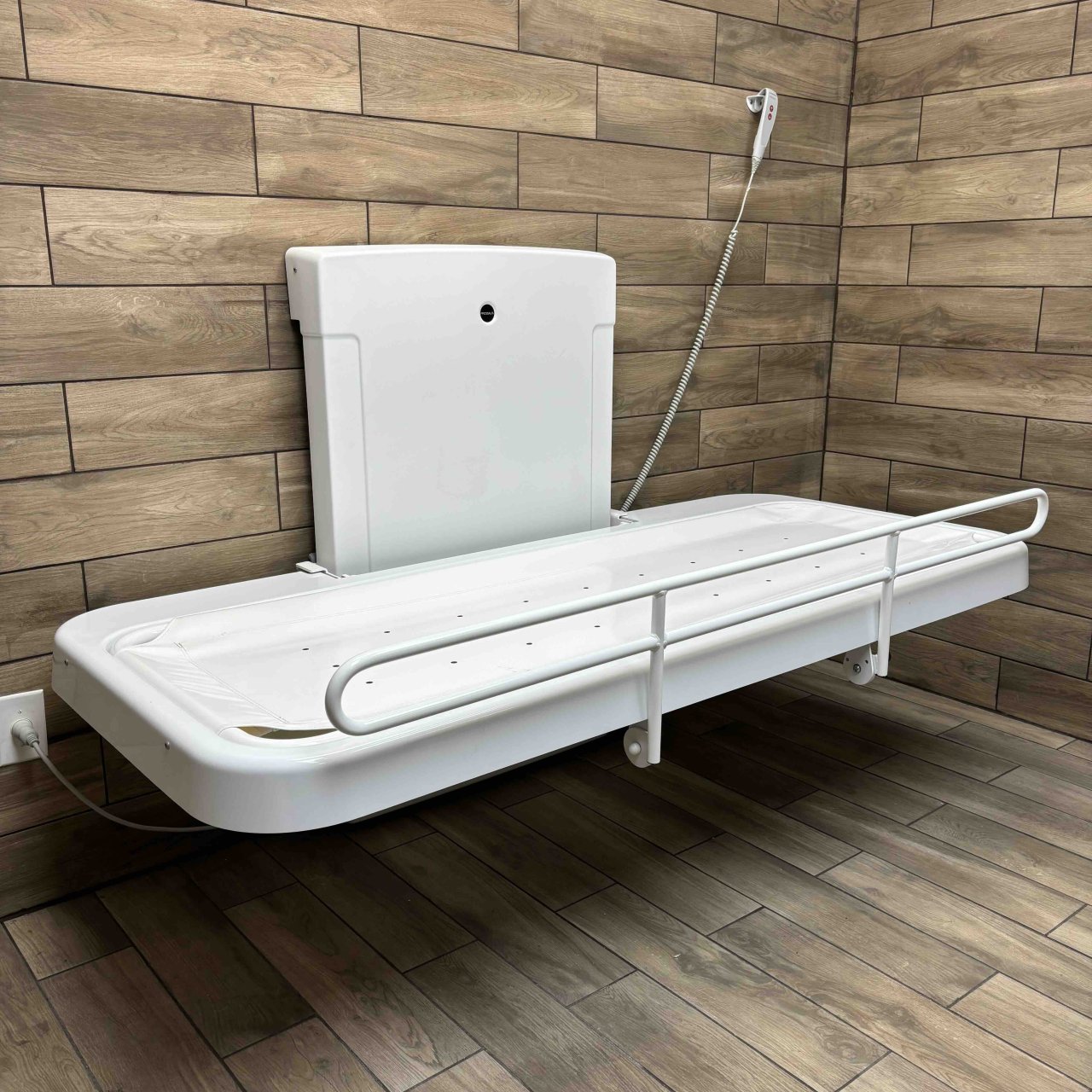 Adult-sized changing table in a wooden room.