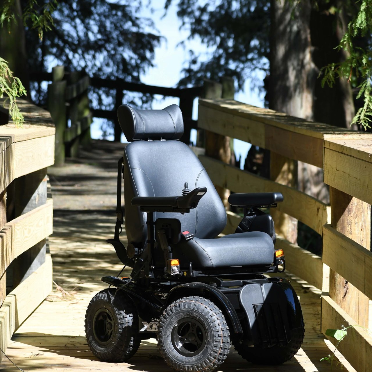 All terrain wheelchair on a wooden walkway.